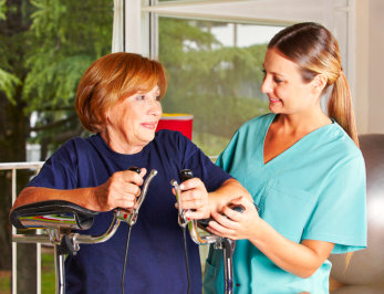 elderly woman with her physical therapist